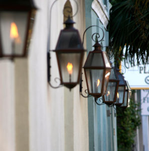 a row of gas lanterns on the exterior of historic block of homes in Charleston, SC